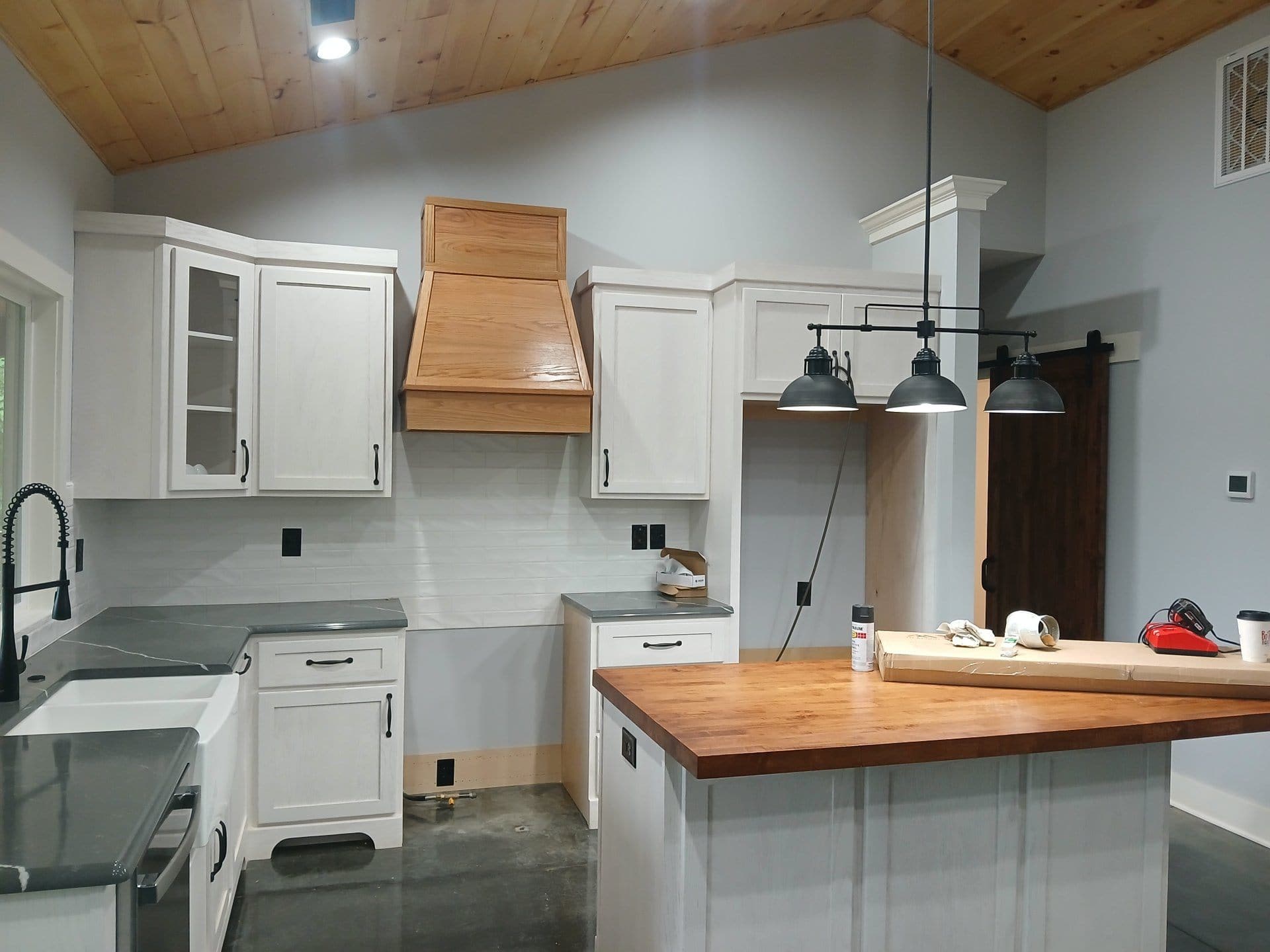 Finished kitchen with custom cabinetry and wood range hood built by Build By Manny in Knoxville, TN