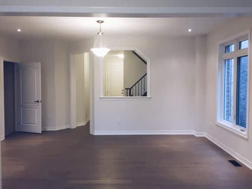 Finished living room with crown molding and tall baseboard trim by Build By Manny in Knoxville, TN