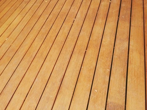 Freshly stained wood deck boards showing grain and spacing, deck maintenance in East Tennessee