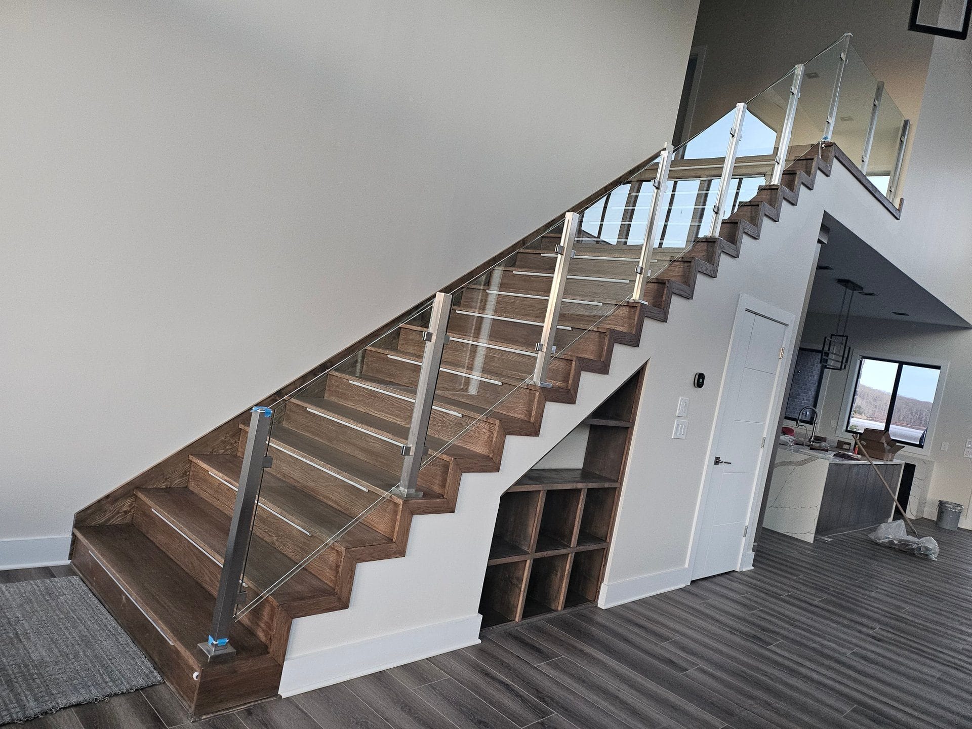 Custom staircase with glass railing and hardwood treads built by Build By Manny in Knoxville, TN